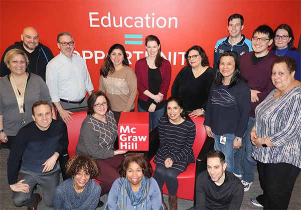 McGraw-Hill Employees holding the red cube logo