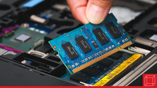 Chip of RAM being placed into computer