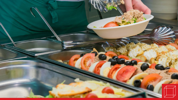 Person making a salad at a buffet