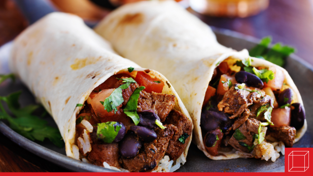 Two full burritos rest on a plate with cilantro.