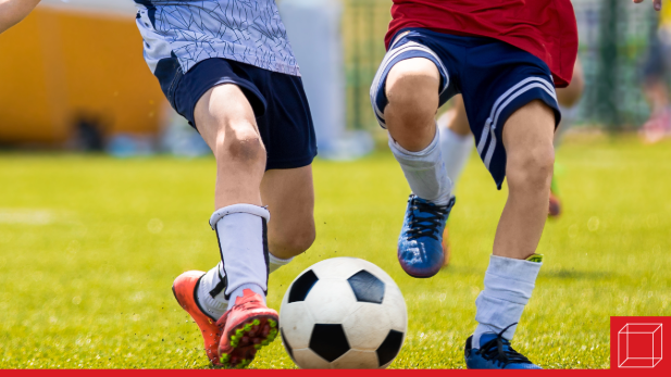 Two soccer players in a challenge over the ball