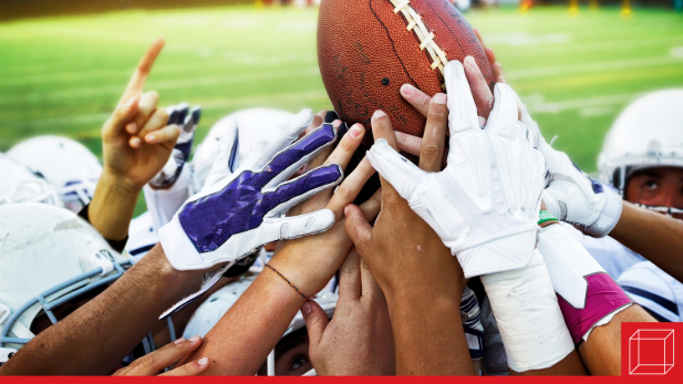 Team holding a football aloft.