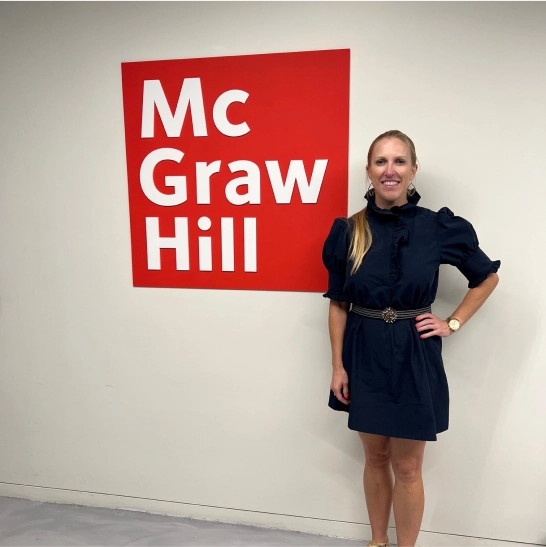 McGraw Hill's Heather Wollerman standing next to McGraw Hill Logo