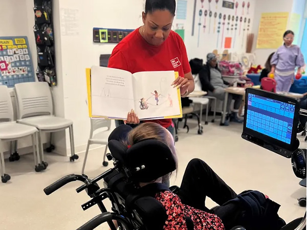 Dominique Pickens reading to students at iHope Academy. 