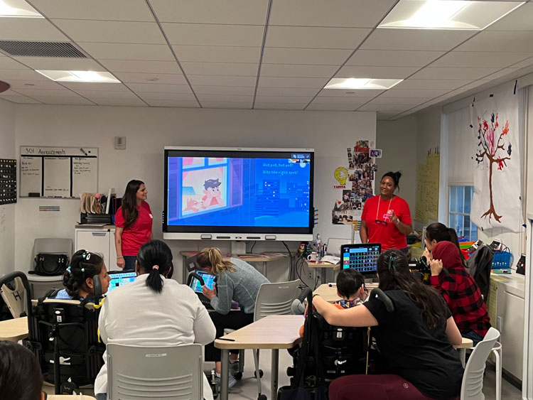 Dominique Pickens (right) and her colleague read aloud to iHope Academy students. 