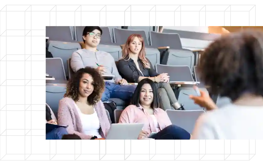 Group of diverse students in a
classroom listening to an instructor.
