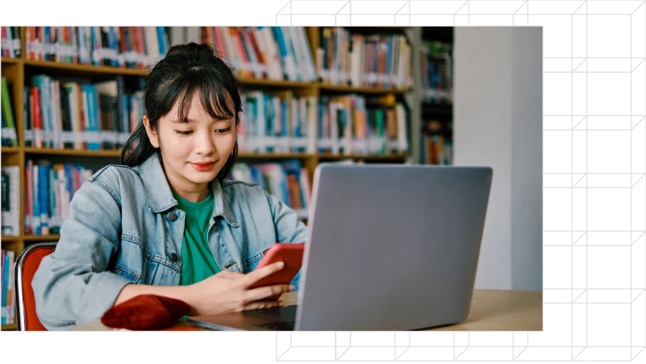 Student using laptop with background graphics.