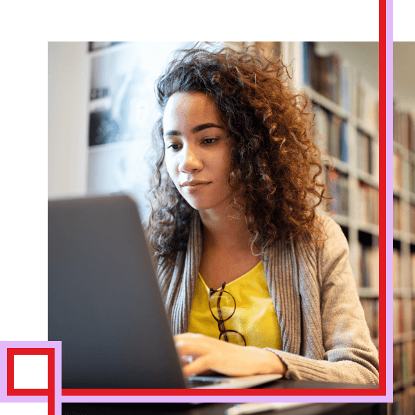 student in library on laptop