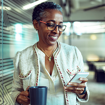 woman in office using smartphone