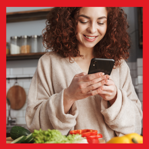 woman using mobile phone in kitchen