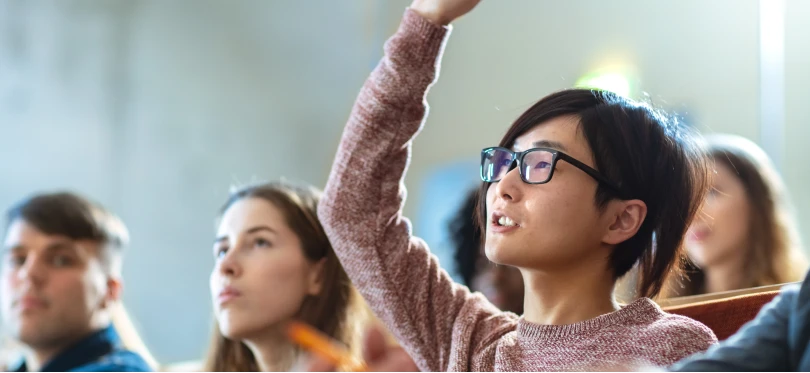 Image of student raising their hand.