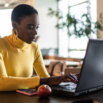 Woman at desk with open laptop