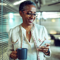 Smiling woman looking at her mobile phone