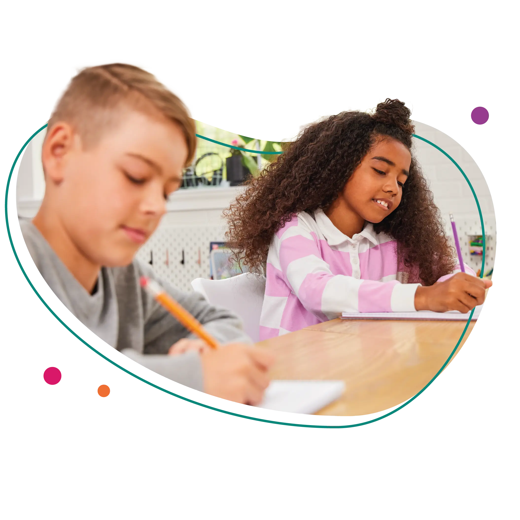 Two students sit at a table writing.
