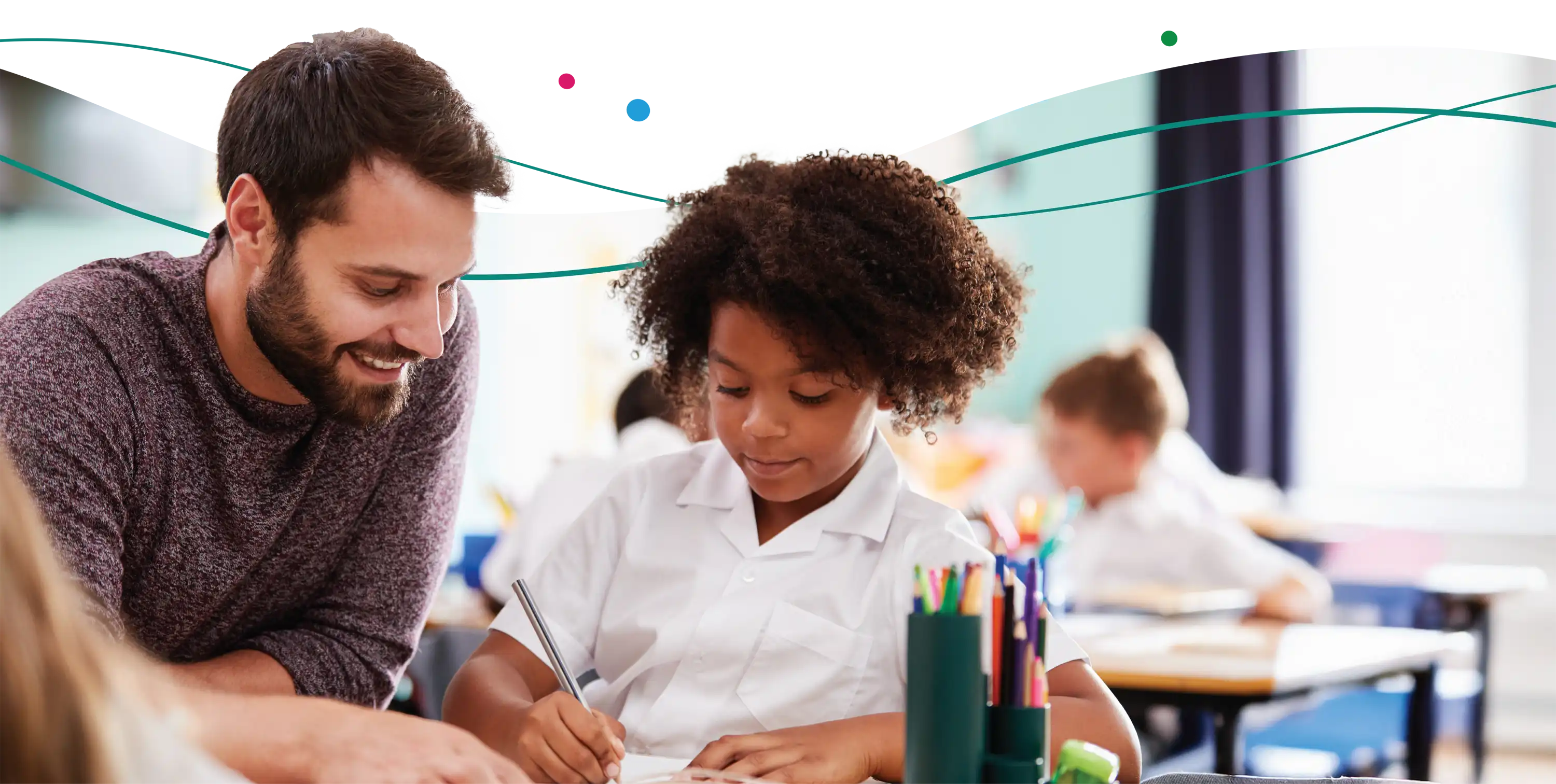 teacher helping a student in a classroom setting