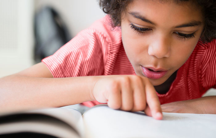 Elementary aged child reading a book