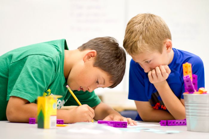 image showing 2 students working together with math manipulatives in a classroom setting
