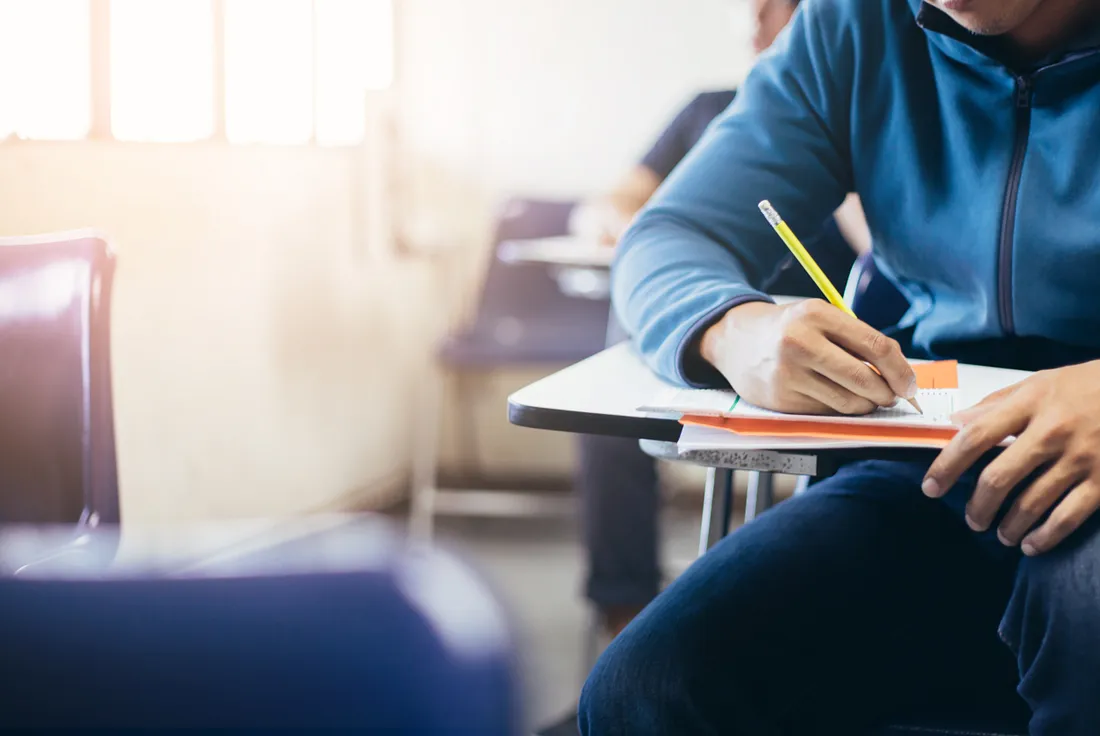Student at desk writing
