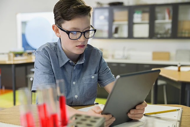 An elementary student using a digital tablet in a laboratory. Retouched rendition of 533977805.jpg for mhbrand.